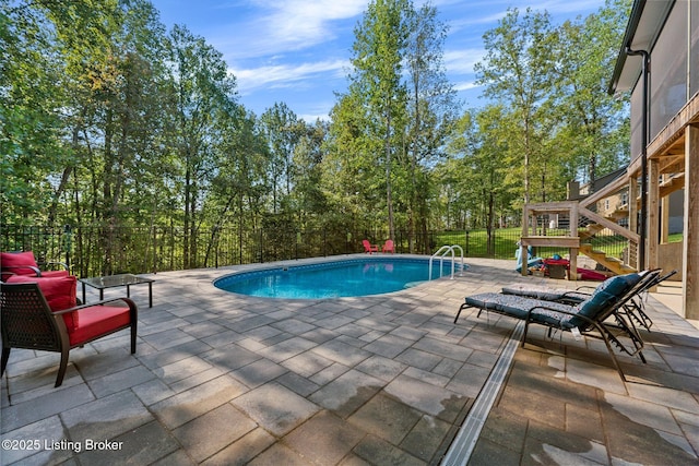 view of swimming pool featuring fence, a fenced in pool, and a patio