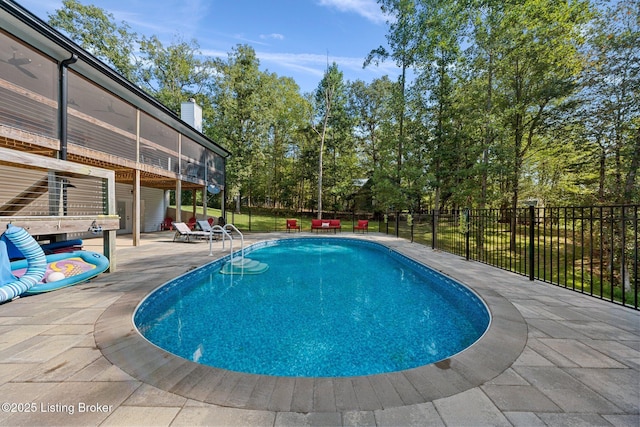 view of swimming pool with a patio, fence, and a fenced in pool