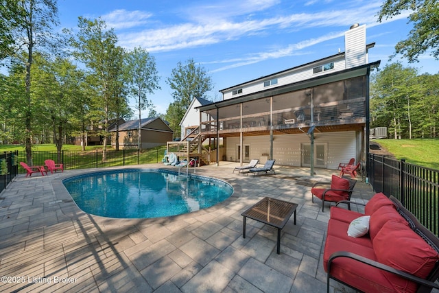 view of pool featuring a patio, stairway, fence, and a sunroom