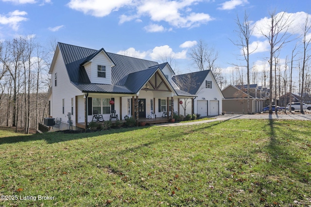 modern inspired farmhouse featuring central AC, metal roof, a porch, and a front lawn