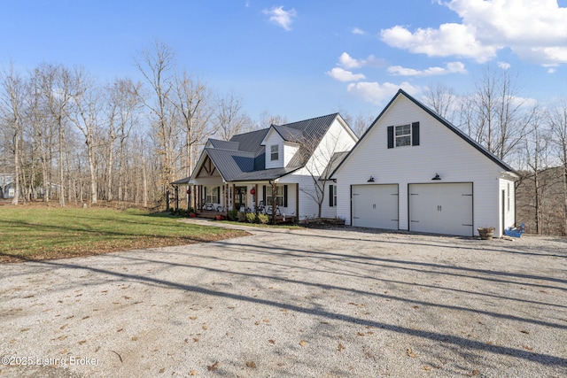 view of front facade featuring a garage, covered porch, driveway, and a front lawn