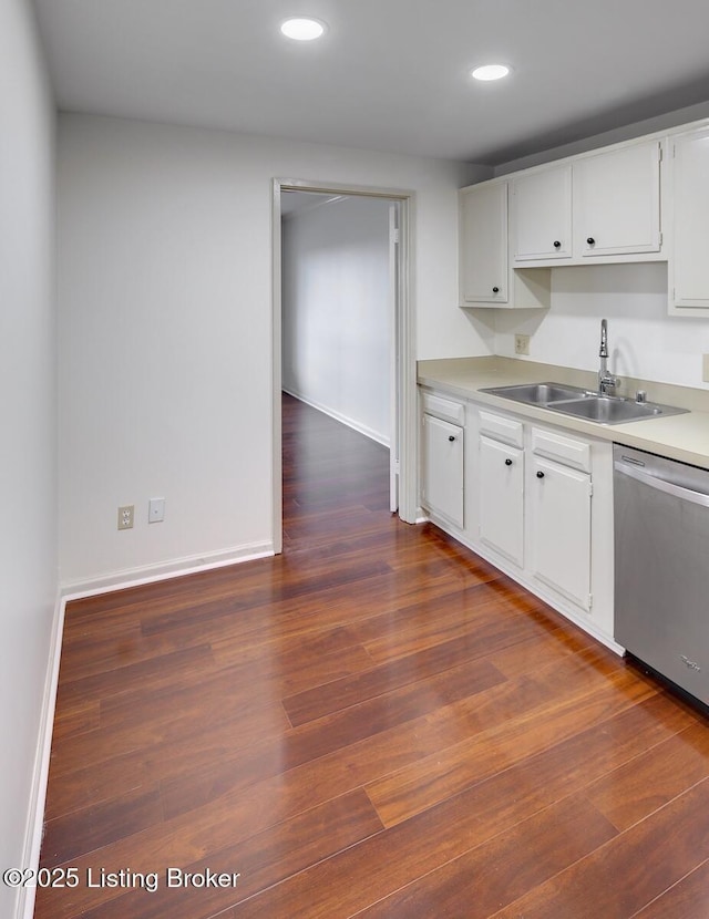 kitchen with sink, stainless steel dishwasher, white cabinets, and dark hardwood / wood-style floors