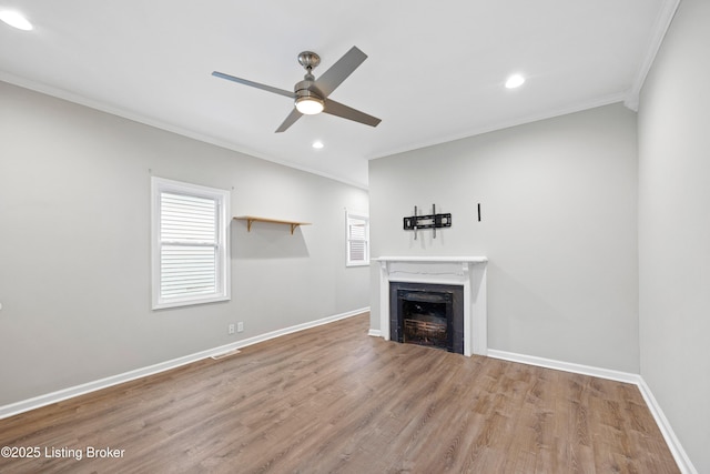 unfurnished living room with crown molding, ceiling fan, and wood-type flooring