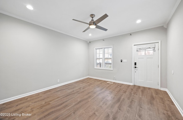 entryway featuring ornamental molding, ceiling fan, and light wood-type flooring