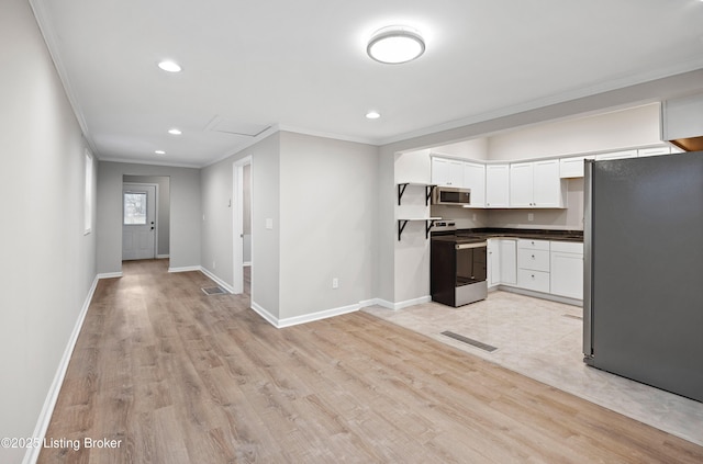 kitchen featuring stainless steel appliances, white cabinetry, ornamental molding, and light hardwood / wood-style floors