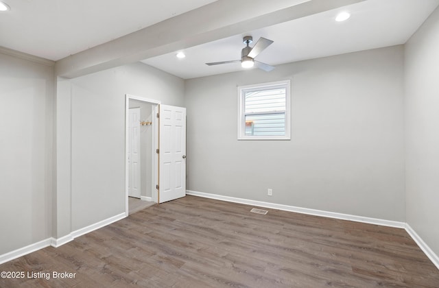 empty room with hardwood / wood-style flooring and ceiling fan