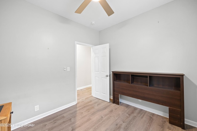 unfurnished bedroom with ceiling fan and light wood-type flooring