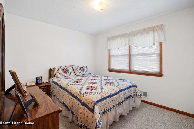 carpeted bedroom featuring a textured ceiling