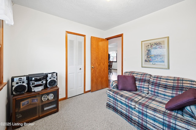 interior space with a textured ceiling and carpet flooring