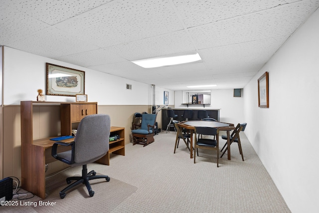 carpeted office featuring a paneled ceiling