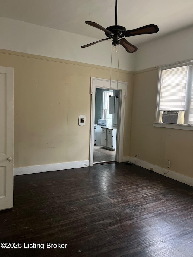 unfurnished room with washer and clothes dryer, cooling unit, and dark hardwood / wood-style flooring