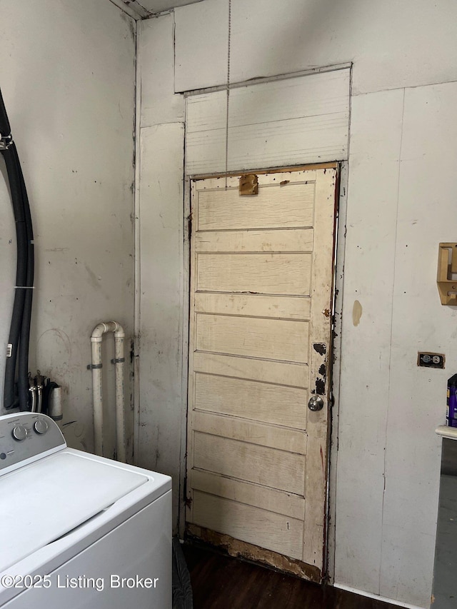 washroom featuring dark hardwood / wood-style flooring and washer / dryer