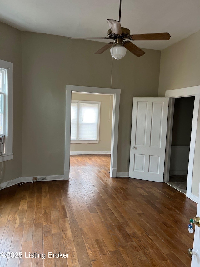 spare room with dark wood-type flooring and ceiling fan