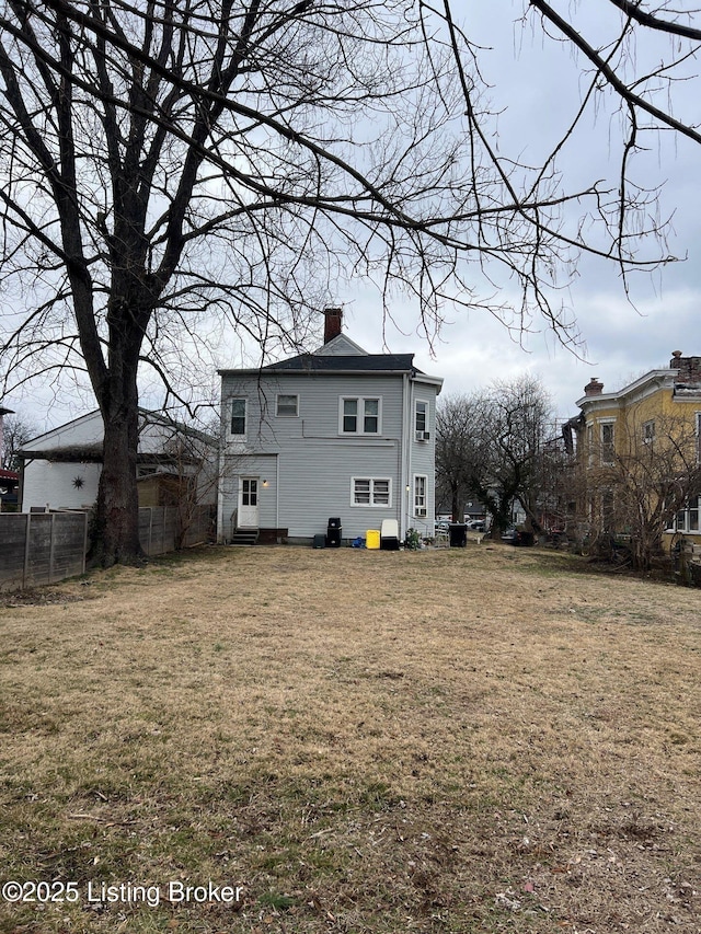 rear view of property with a yard