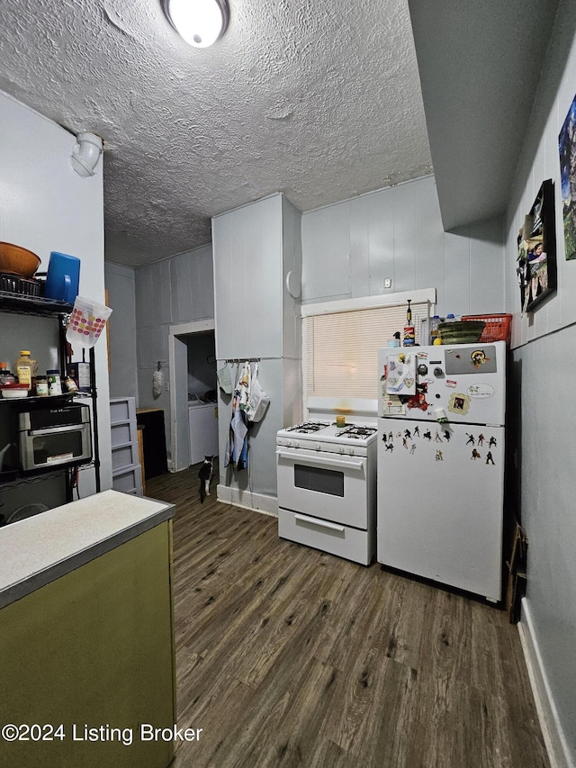 kitchen with white cabinets, white appliances, dark hardwood / wood-style floors, and a textured ceiling