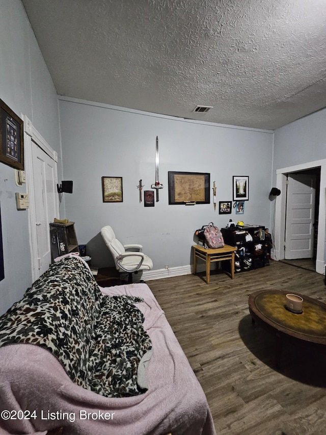 living room featuring dark hardwood / wood-style floors and a textured ceiling