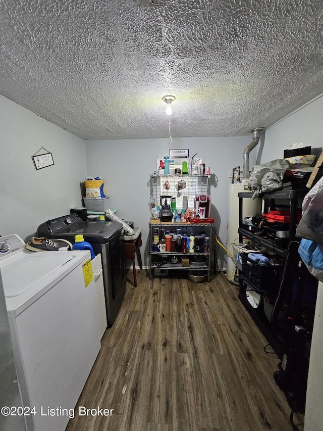 laundry area with water heater, washing machine and dryer, a textured ceiling, and dark hardwood / wood-style flooring