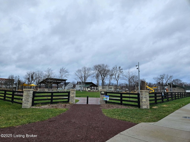 view of gate with a yard