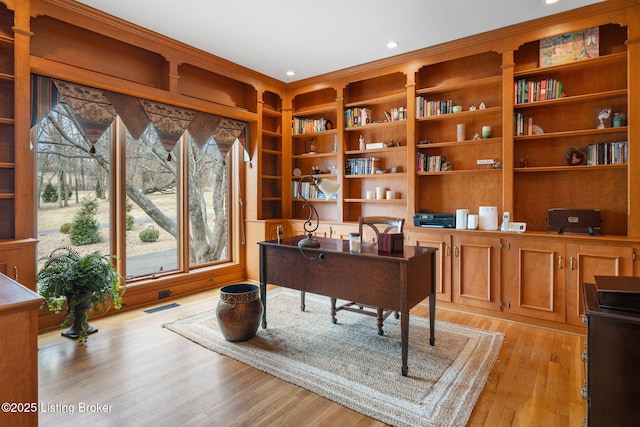 home office with recessed lighting, visible vents, and light wood-style flooring