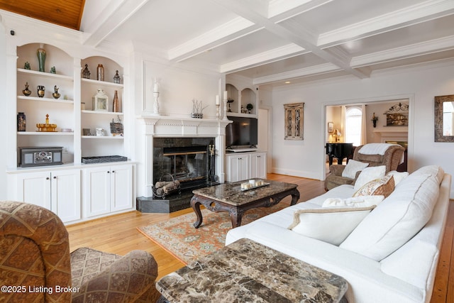 living area with beamed ceiling, light wood-type flooring, coffered ceiling, and a high end fireplace