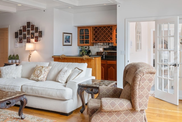 living room with light wood finished floors, beamed ceiling, recessed lighting, and wet bar