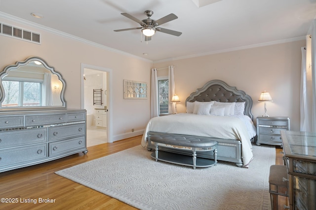 bedroom featuring wood finished floors, visible vents, and crown molding