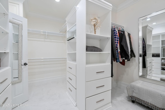 walk in closet with marble finish floor