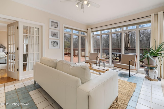 sunroom / solarium with a ceiling fan and french doors