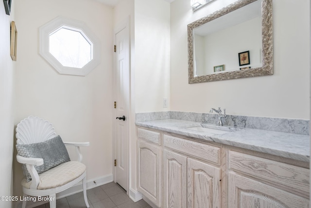 bathroom featuring vanity, baseboards, and tile patterned floors