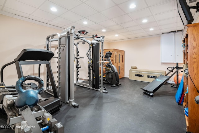 workout room featuring recessed lighting, a paneled ceiling, and baseboards