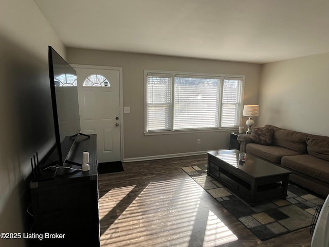 living area with baseboards and dark wood-style flooring