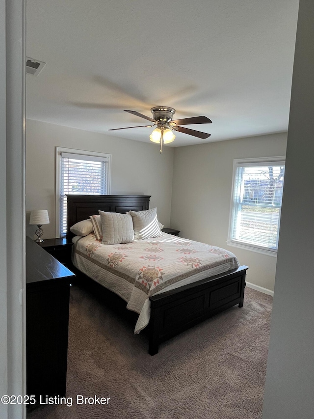 bedroom with carpet floors, ceiling fan, visible vents, and baseboards