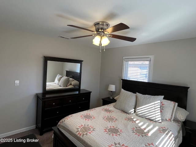 carpeted bedroom featuring ceiling fan, visible vents, and baseboards