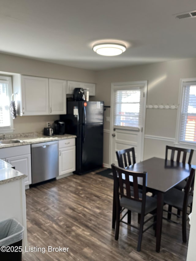 dining area with dark wood-style floors and visible vents