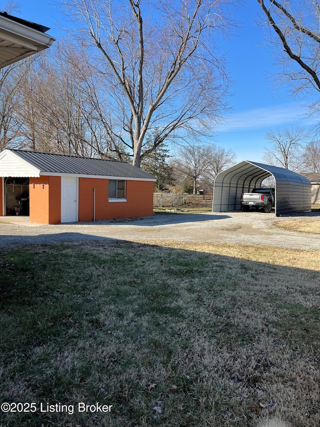 view of yard with a detached carport and driveway