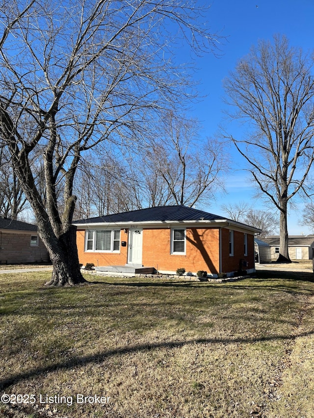 view of front of home with a front yard and brick siding