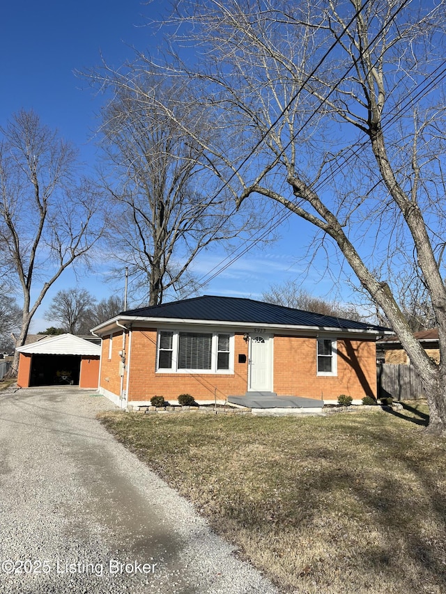 ranch-style home featuring a garage, brick siding, and a front lawn