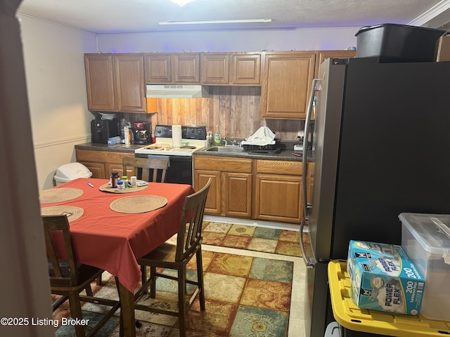 kitchen featuring range with electric stovetop and stainless steel fridge