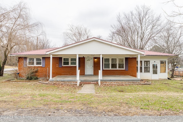 single story home with a porch and a front lawn