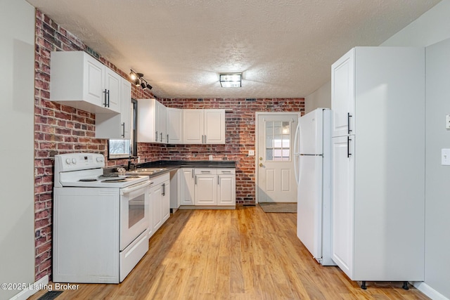 kitchen featuring white cabinetry, white appliances, a textured ceiling, and light wood-type flooring