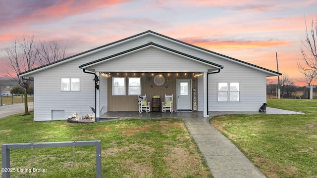 view of front of home featuring a yard and covered porch