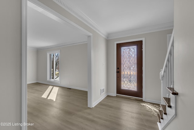 entryway with ornamental molding and light hardwood / wood-style flooring