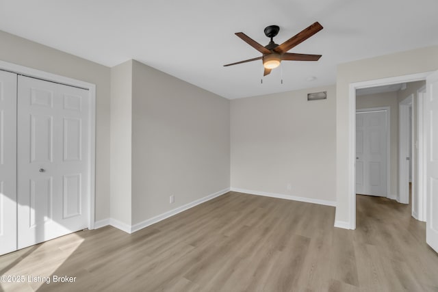 unfurnished bedroom featuring a closet, ceiling fan, and light wood-type flooring