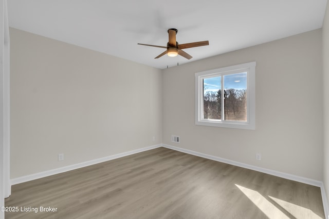 empty room featuring ceiling fan and light wood-type flooring