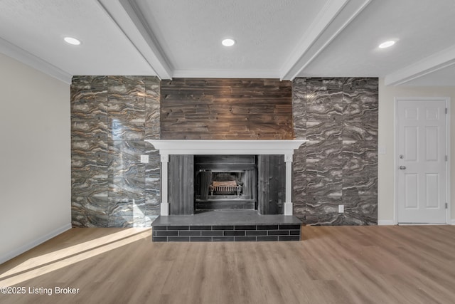 details with crown molding, hardwood / wood-style floors, beam ceiling, and a textured ceiling