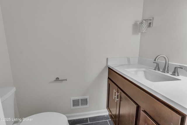 bathroom with vanity, tile patterned floors, and toilet