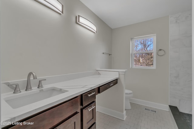 bathroom featuring vanity, tile patterned floors, and toilet