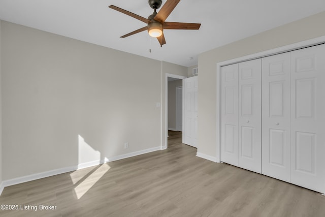 unfurnished bedroom with a closet, ceiling fan, and light wood-type flooring