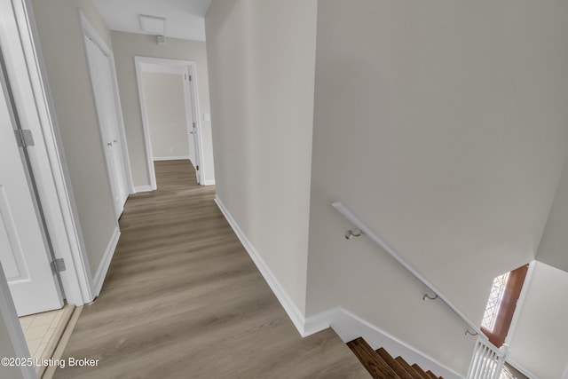 corridor with light hardwood / wood-style floors