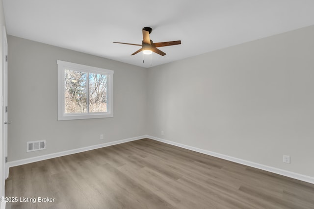 spare room with ceiling fan and light wood-type flooring